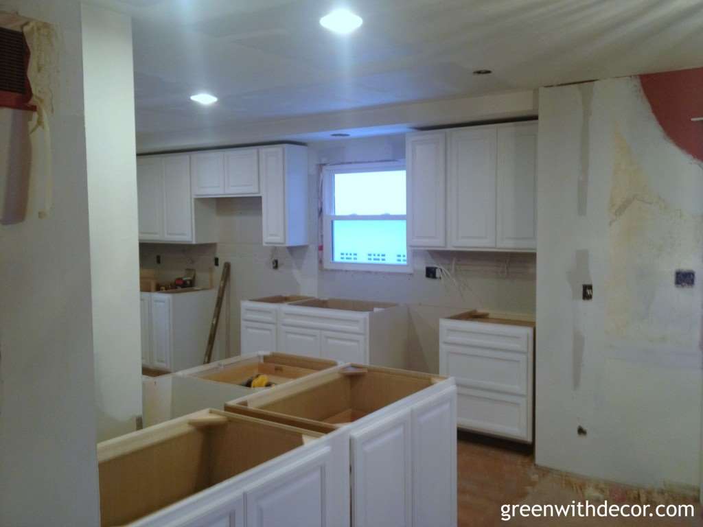 White cabinets installed in the kitchen! If you need a lower cabinet for a tight spot, think about using an upper cabinet. | Green With Decor