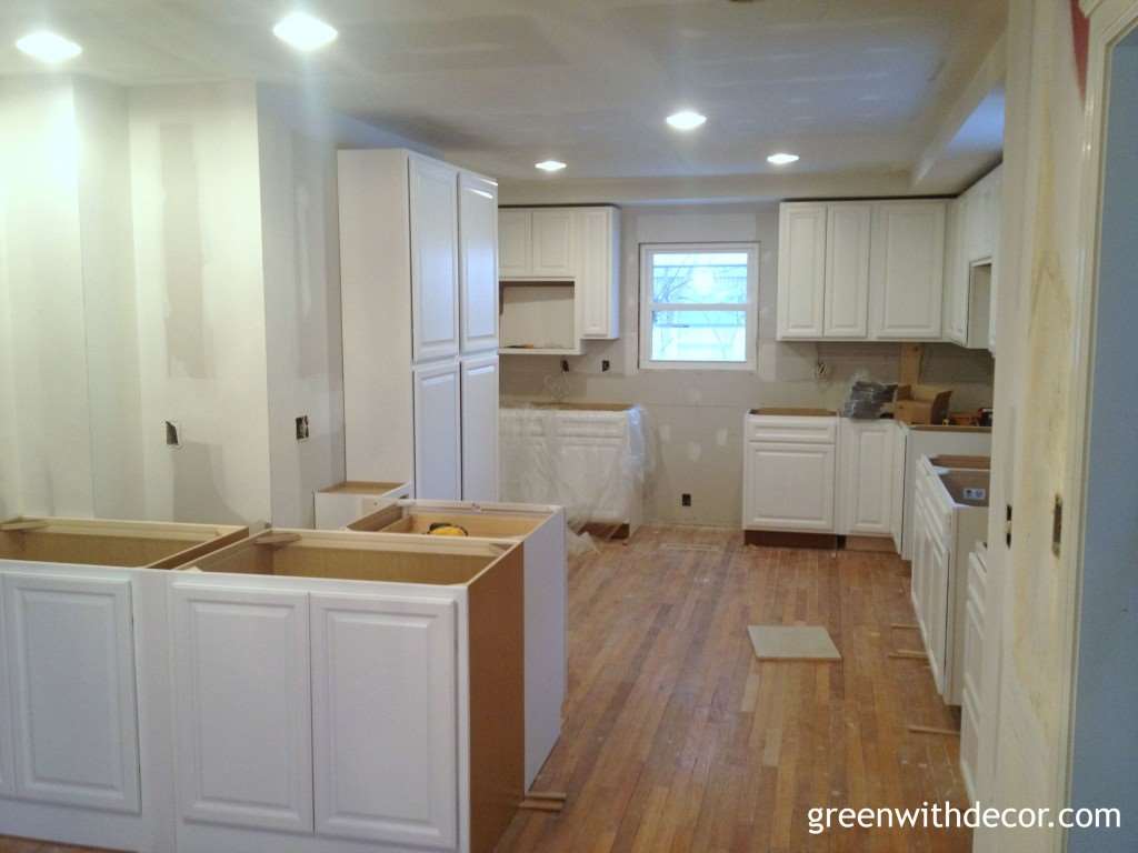 White cabinets installed in the kitchen! If you need a lower cabinet for a tight spot, think about using an upper cabinet. | Green With Decor