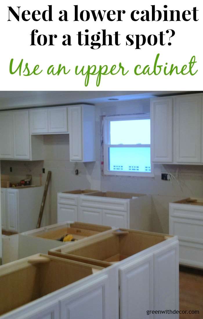 White cabinets installed in the kitchen! If you need a lower cabinet for a tight spot, think about using an upper cabinet. | Green With Decor 