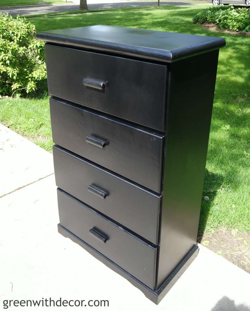 Black painted dresser sitting in driveway