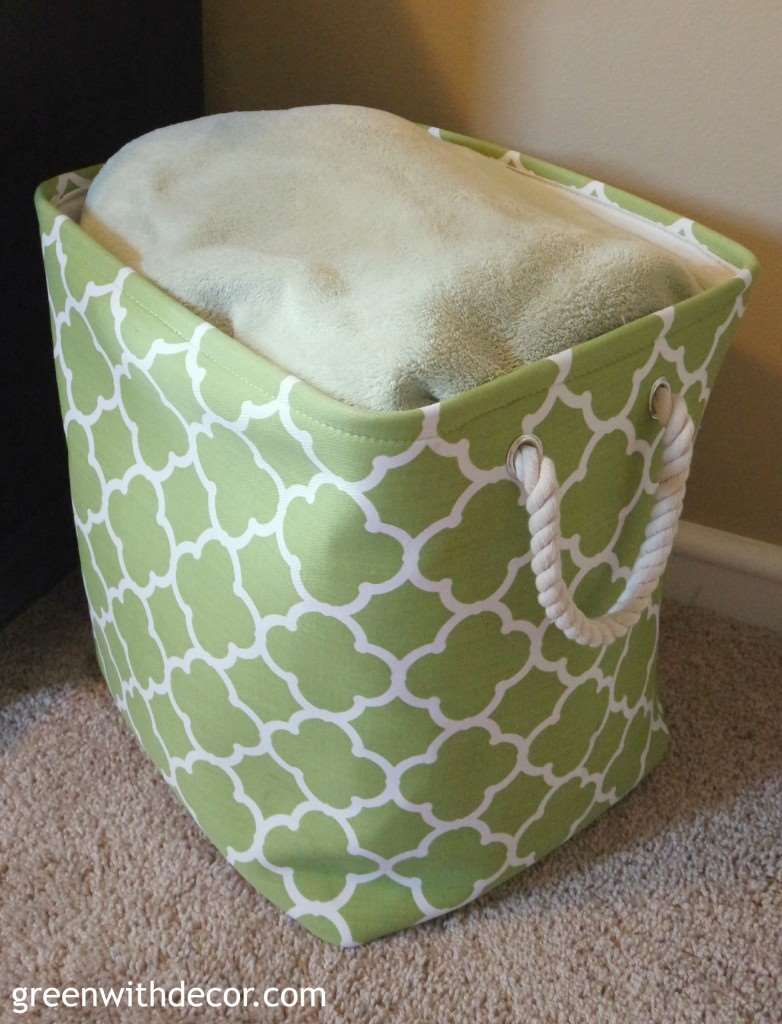 A green hamper filled with towels