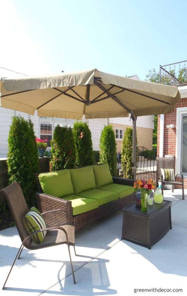 This backyard looks awesome! I love the big couch and umbrella! How relaxing! | Green With Decor – 5 top priorities when planning a backyard oasis