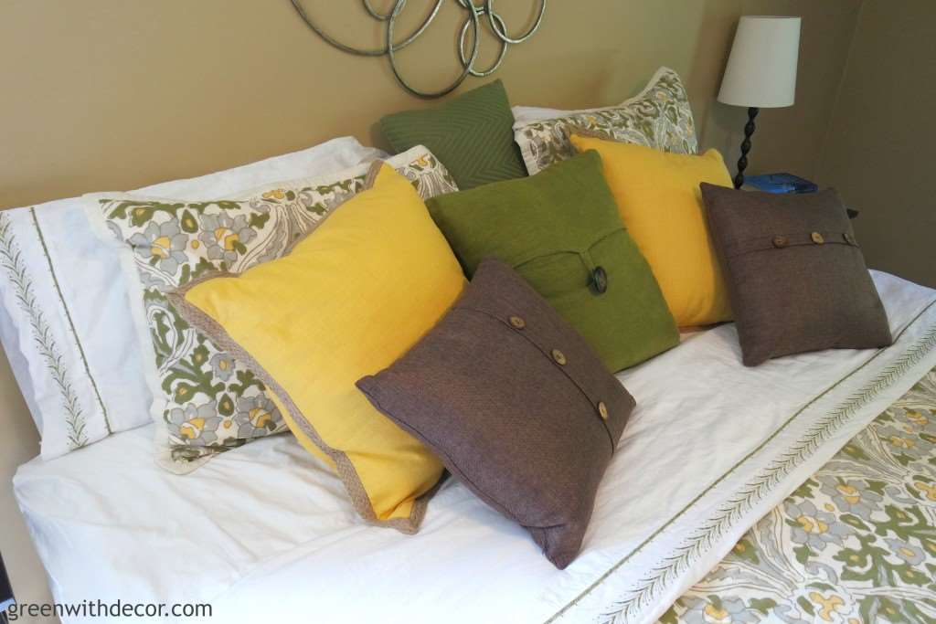 Oh my gosh, what a cute master bedroom! I love all the throw pillows!| Green With Decor