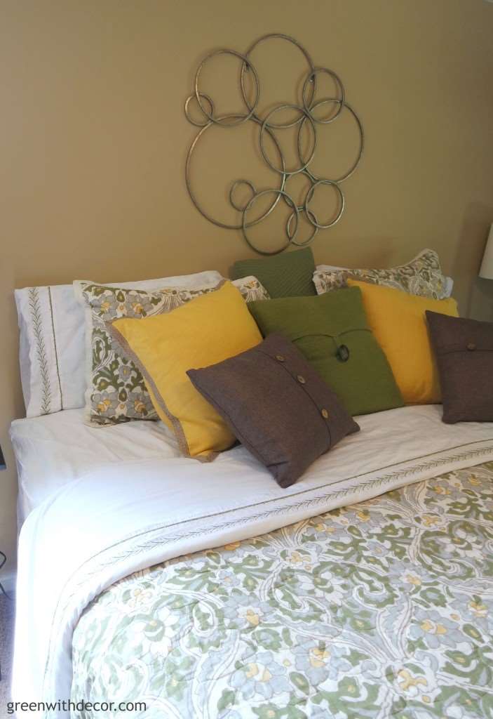 Oh my gosh, what a cute master bedroom! I love all the throw pillows!| Green With Decor