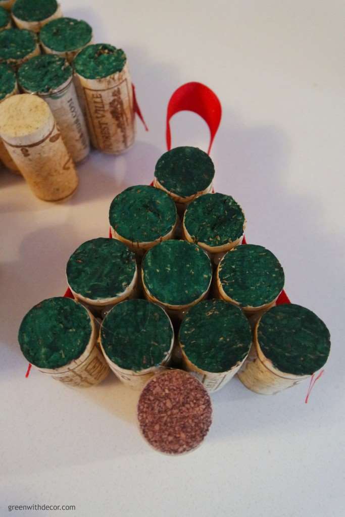 The finished cork ornament, with the ends painted green and red ribbon glued on