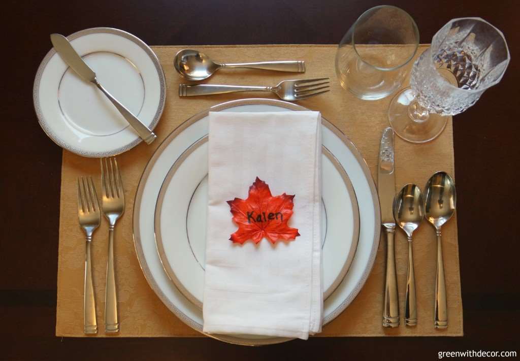 A table setting with a fall leaf that reads "Kalen" on it