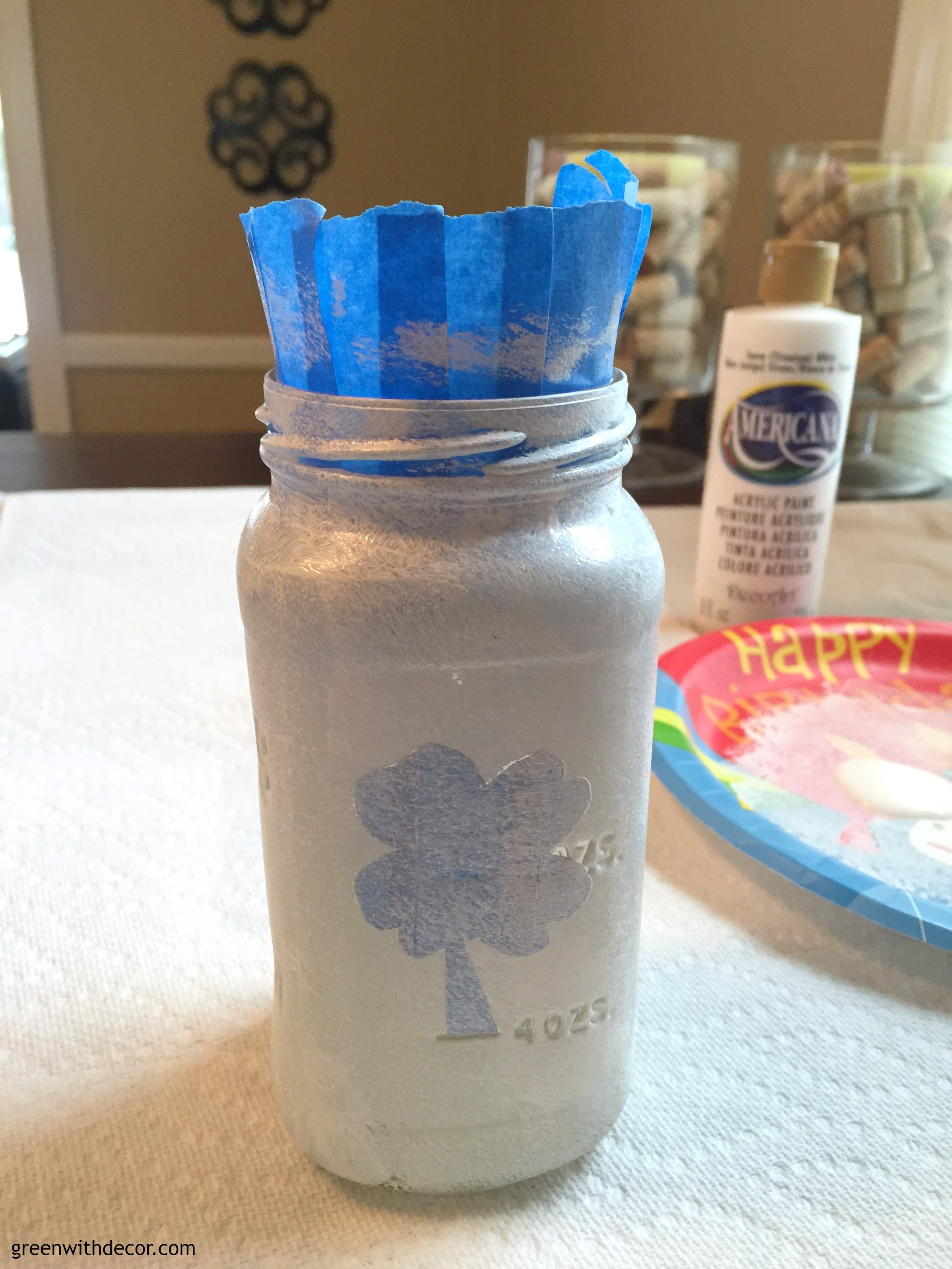 A fun St. Patrick’s Day craft with Mason jars. How cute are these? And she used old spaghetti jars instead of Mason jars, what a great idea! | Green With Decor 