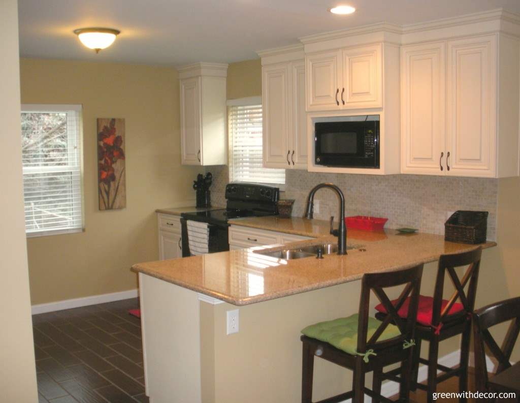 This kitchen renovation is crazy! They started with an old space, and now it’s so pretty with the cream and bronze finishes! | Green With Decor