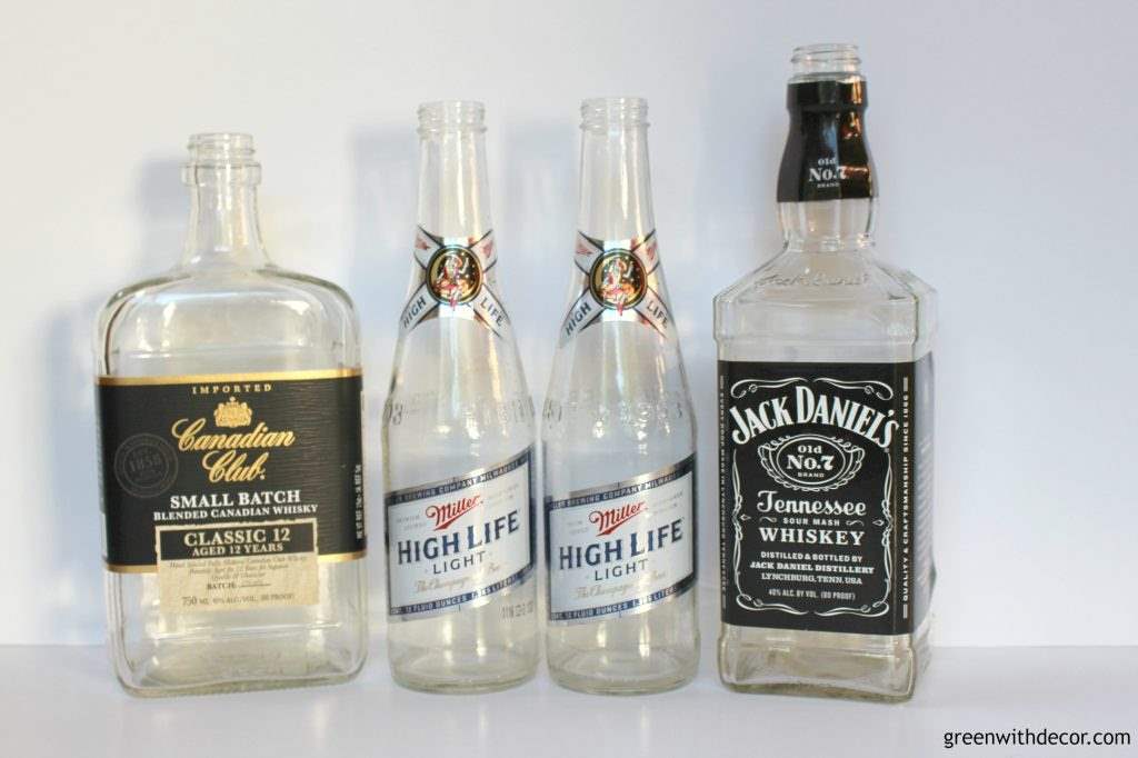 Empty beer and liquor bottles to use for a DIY soap dispenser