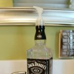 A Jack Daniels DIY soap dispenser with text overlay, “An easy DIY: A liquor bottle soap dispenser”