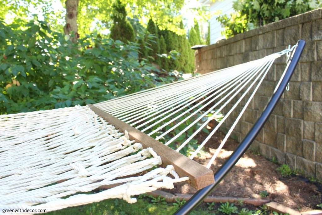 Relaxing with a hammock in the backyard. Love the sleek look of that black hammock stand! 