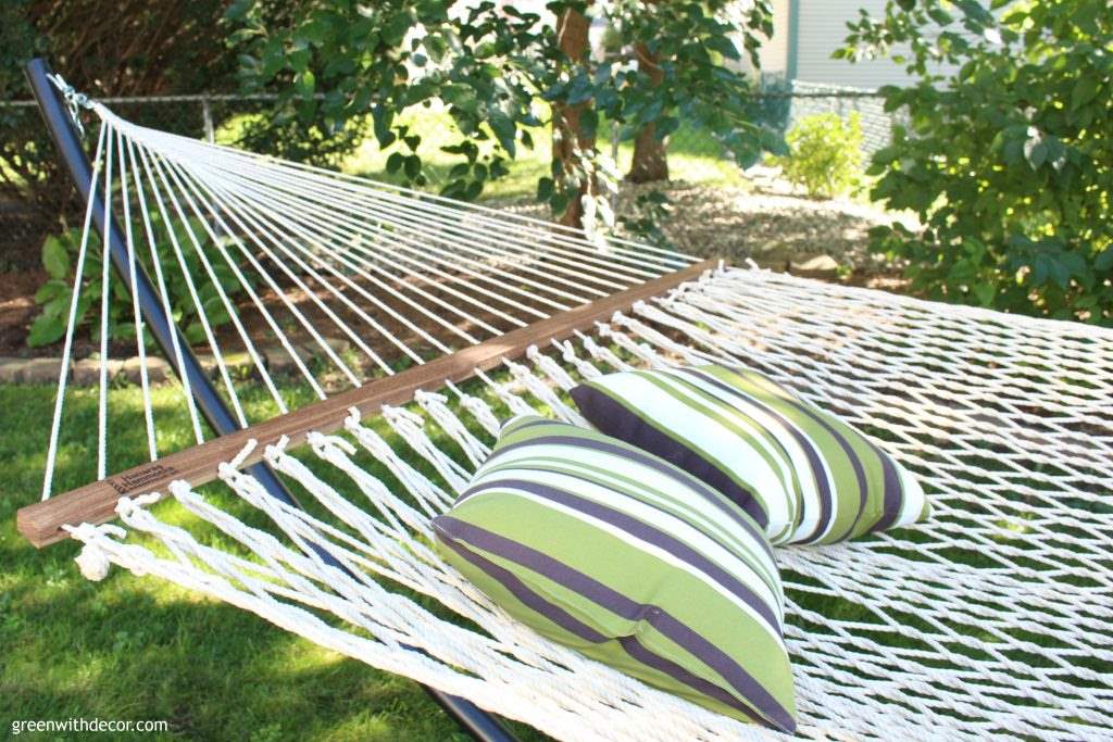 Relaxing with a hammock in the backyard. Love the sleek look of that black hammock stand! 