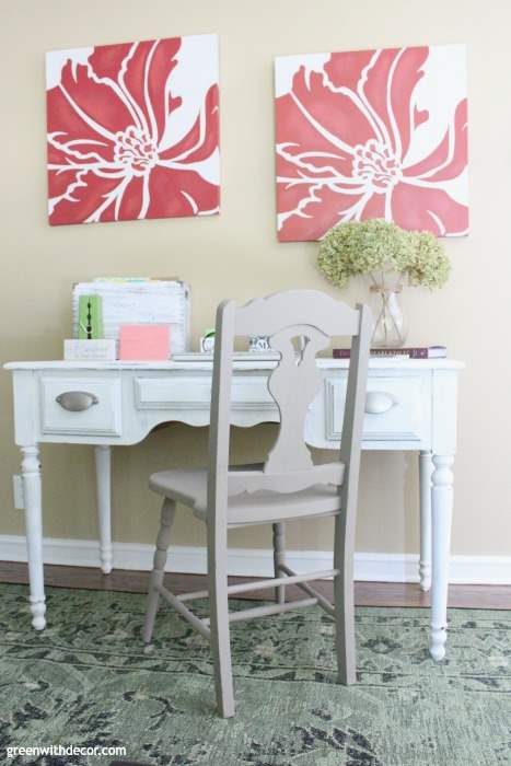 Home office idea in a living room with red canvases