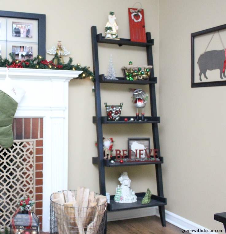 Decorating the living room for Christmas on a budget. Great budget-friendly holiday decorating ideas here! I love all the ribbon and ornaments she uses to make the family room feel festive.