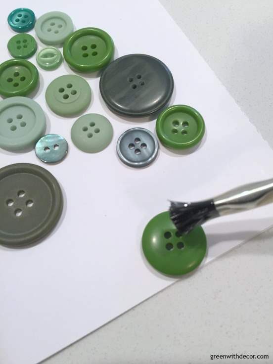 Use a small paintbrush to place glue on the back of the buttons and glue them to the cardstock