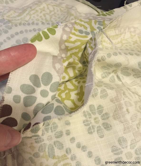 How to DIY a throw pillow from extra fabric. A perfect excuse to make a pillow and a great way to use old fabric instead of throwing it away. Plus you could do this with Christmas or other holiday fabric as a cheap way to get seasonal throw pillows.