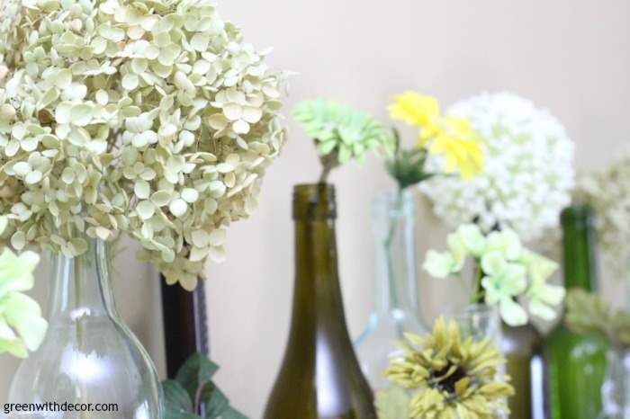 An easy spring mantel decorating idea with old glass bottles and wine glasses. This is so pretty and would be easy to put together!