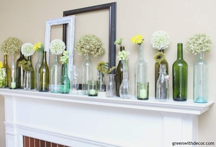 An easy spring mantel decorating idea with old glass bottles and wine glasses. This is so pretty and would be easy to put together!