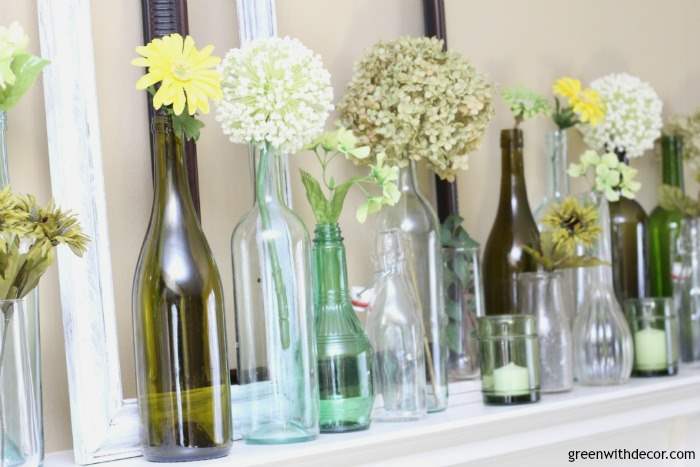 An easy spring mantel decorating idea with old glass bottles and wine glasses. This is so pretty and would be easy to put together!