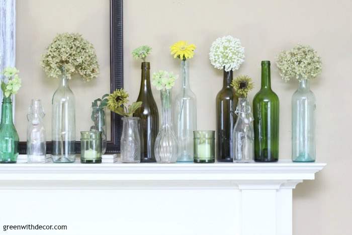 An easy spring mantel decorating idea with old glass bottles and wine glasses. This is so pretty and would be easy to put together!