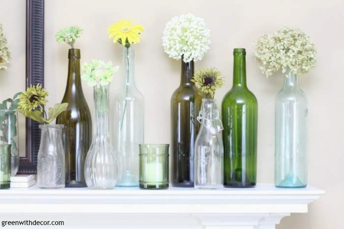 An easy spring mantel decorating idea with old glass bottles and wine glasses. This is so pretty and would be easy to put together!