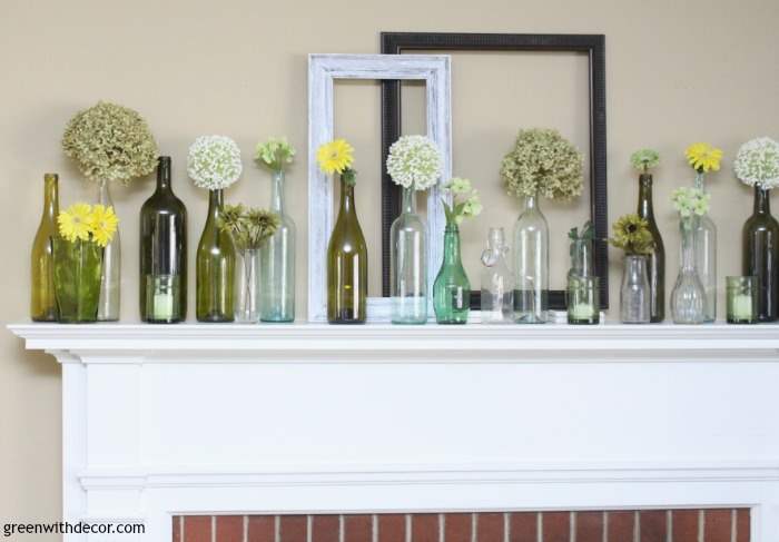 An easy spring mantel decorating idea with old glass bottles and wine glasses. This is so pretty and would be easy to put together!