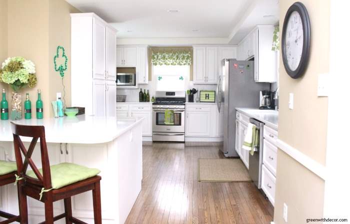 https://greenwithdecor.com/wp-content/uploads/2017/03/st-patricks-day-party-decorating-white-kitchen-green-accents-wood-floor-quartz-counters-clock-jute-rug.jpg