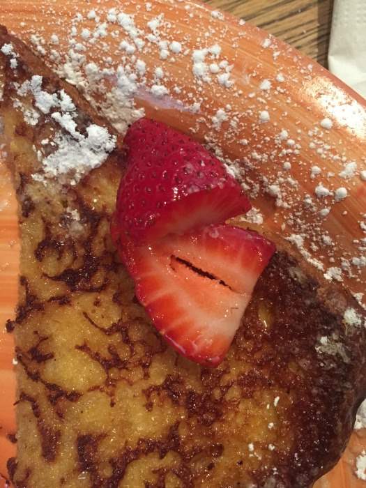 French toast with powdered sugar and fresh strawberries