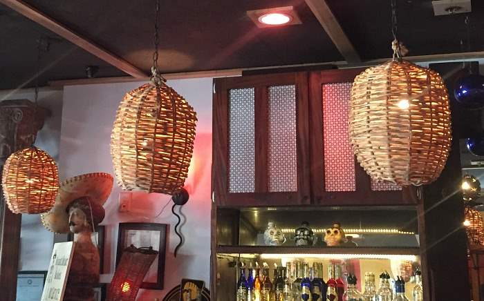 Basket light fixtures over a bar
