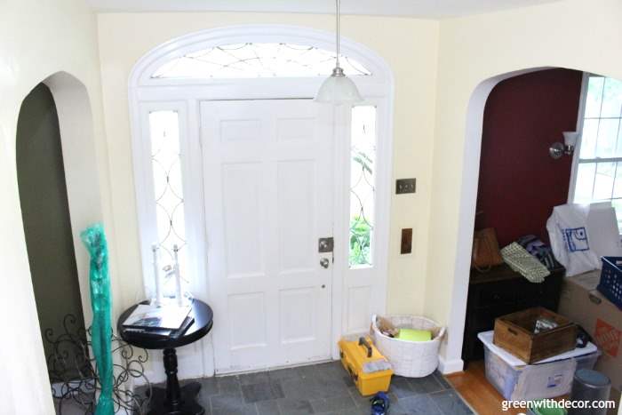 A yellow foyer with a white front door