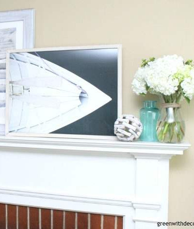 What to use for a summer mantel | Love the beachy picture frames with the colored glass vases and rope sphere | summer decorating ideas for the mantel | summer decor | mantel decorating ideas 