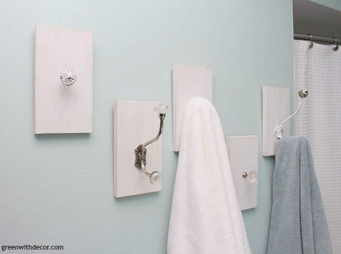 Towel racks made from old drawer pulls hold towels on a blue wall