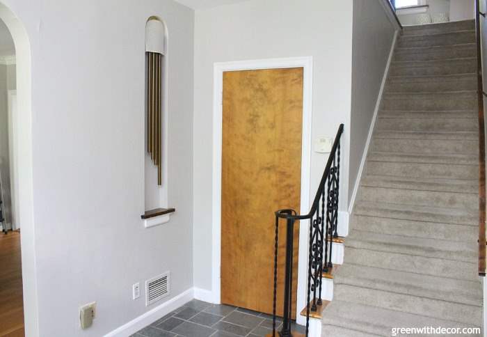 Gorgeous shade of gray: Agreeable Gray by Sherwin Williams. This foyer has so much old charm, the gray paint brightens it right up!