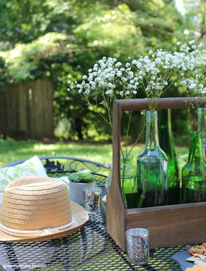 https://greenwithdecor.com/wp-content/uploads/2017/06/easy-patio-decorating-ideas-summer-centerpiece-hat-merucry-candleholder-old-bottles.jpg