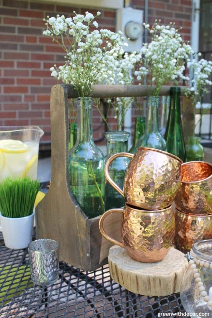 Moscow Mule copper mugs in front of a wooden toolbox