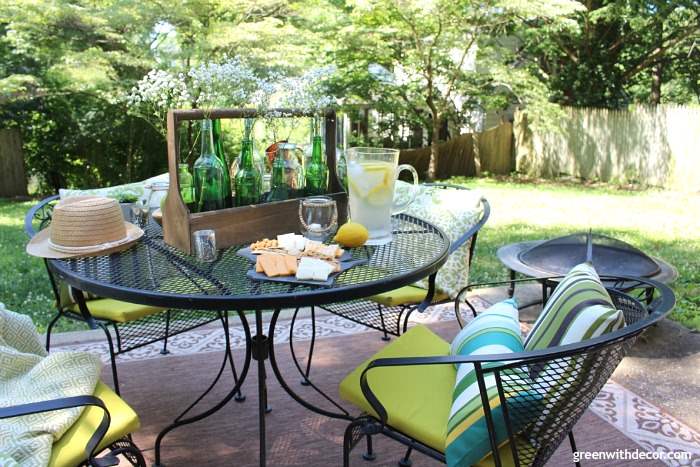 A black patio set in a wooded backyard