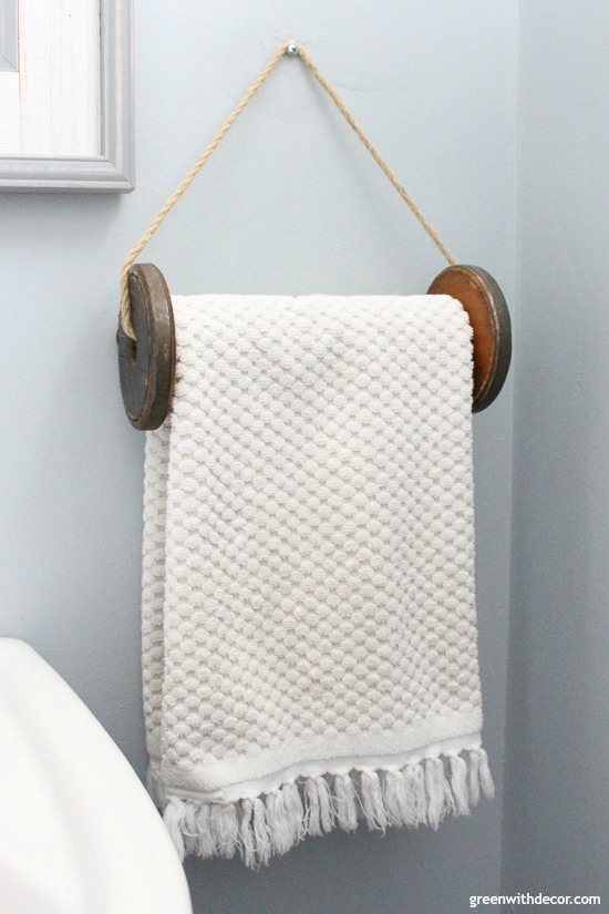 DIY wooden spool towel rack against a blue wall