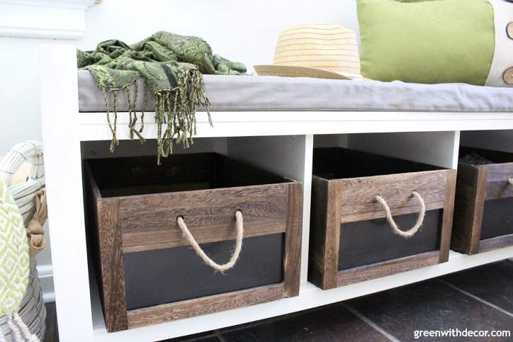 Wooden crates sit on a bench in the foyer