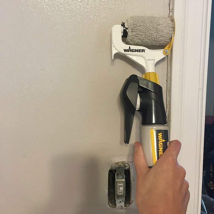 The Wagner Smart Edge tool painting trim in a room