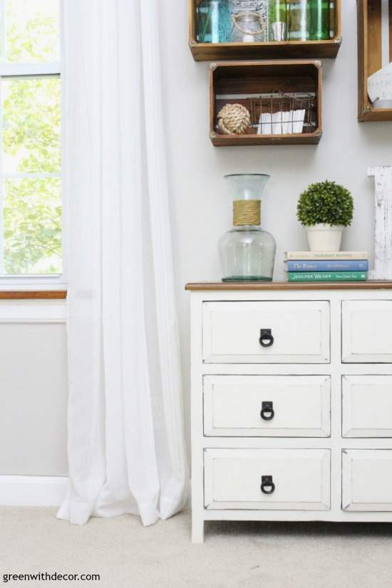 How to find your decorating style – chippy farmhouse white dresser in front of a gray wall