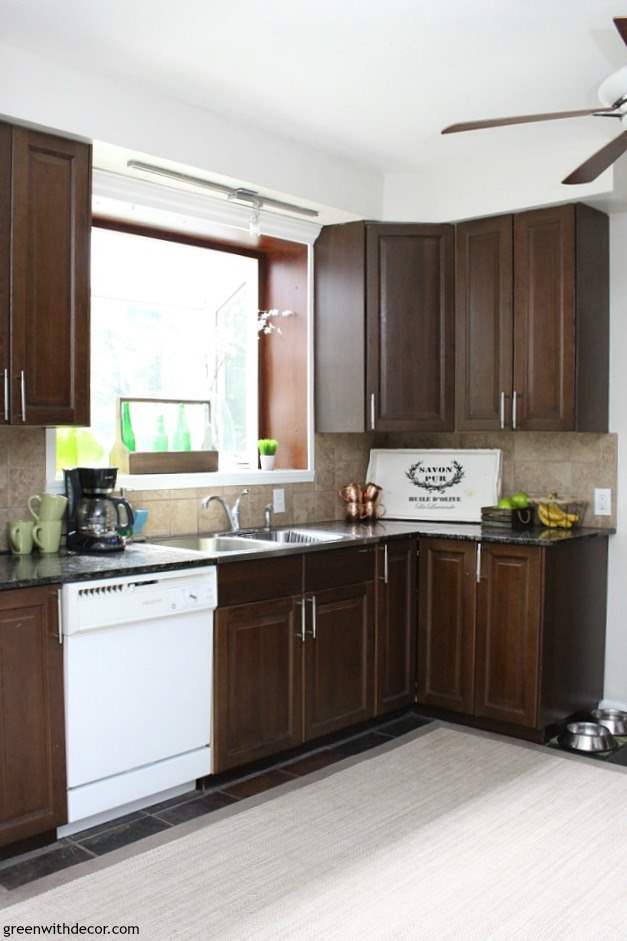 7 ways to update your kitchen when you can't renovate whether you're renting or don't have the budget for a kitchen renovation right now. Love the white tray on the counter to brighten things up in this dark kitchen.