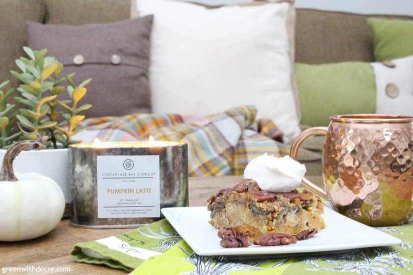 A fall candle, pecan pie and neutral pillows