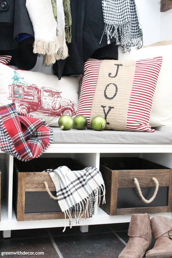 Christmas decorating ideas for the foyer. Love those rustic wood rope crates with the pretty Christmas throw pillows and scarves!