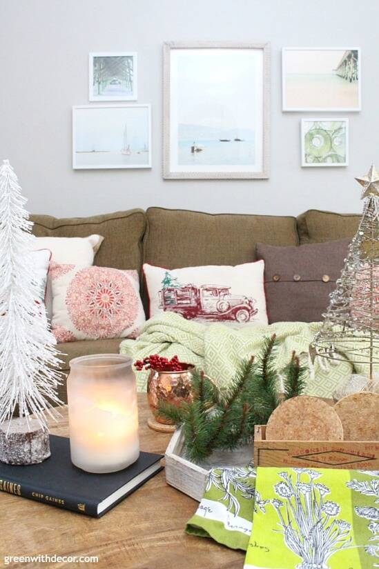 A traditional Christmas living room filled with red, green and metallic decor. Love all of the mini Christmas trees and festive pillows!