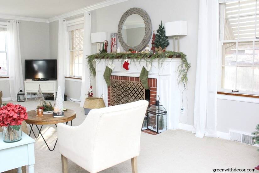 A traditional Christmas living room filled with red, green and metallic decor. Love all of the festive, budget-friendly, easy touches in this living room!