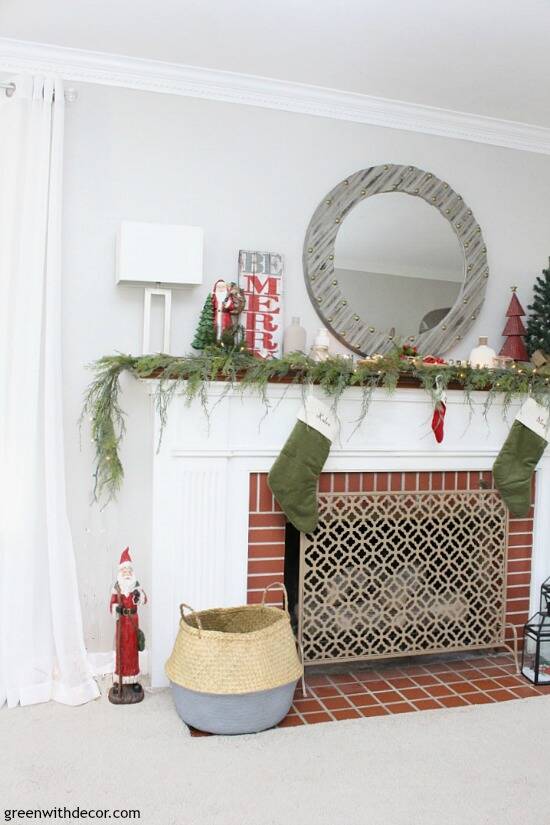 A traditional Christmas mantel - full of red, green, metallic and neutral pieces. Love that faux garland and gorgeous gray wood mirror!