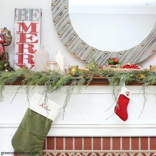A traditional Christmas mantel - full of red, green, metallic and neutral pieces. Love that farmhouse rustic Be Merry sign!