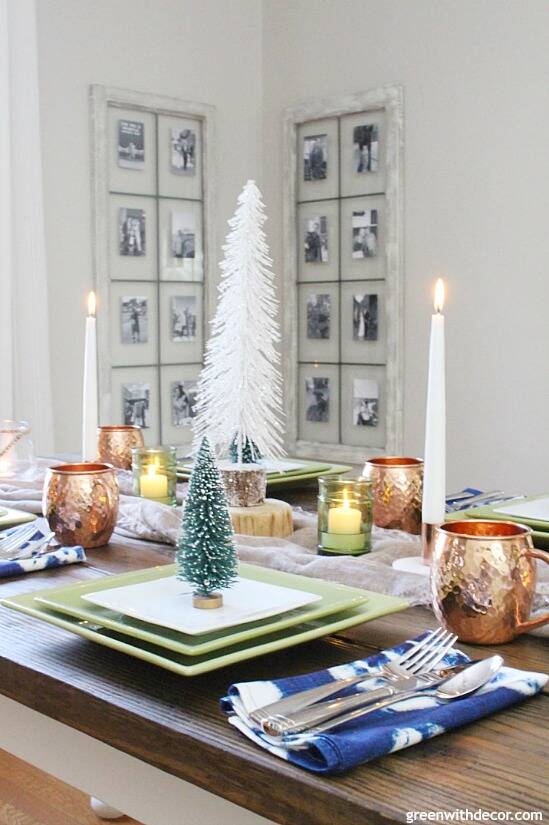 A blue and copper Christmas centerpiece + tablescape - perfect for a costal tablescape! Love that sparkly white mini tree and all of the candles in the center of the table - perfect for the holidays!