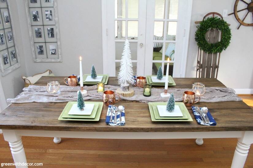 A blue and copper Christmas centerpiece + tablescape - perfect for a costal tablescape! Love the mixture of beachy pieces with metallic mugs and candleholders!