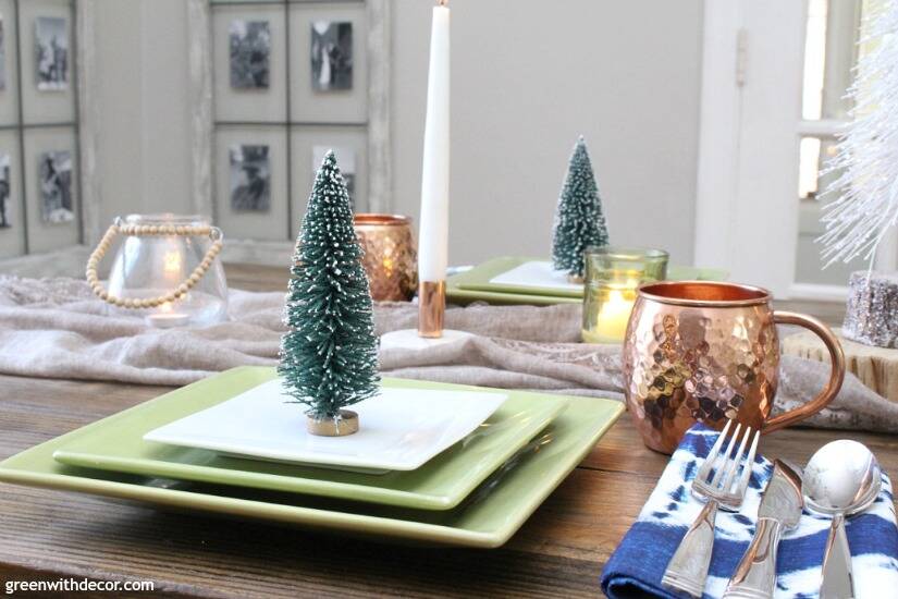 A blue and copper Christmas centerpiece + tablescape - perfect for a costal tablescape! Love those cute little mini Christmas trees at each place setting!